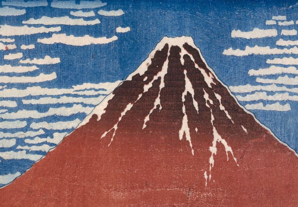 Detail of Red Fuji: a brick-red mountain with snow descending in jagged finger-like streaks, against a graded Prussian blue sky.